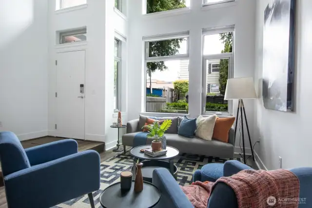 Floor-to-ceiling windows fill the space with natural light.