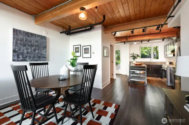 Dedicated dining space under a wood-paneled ceiling with easy access to the kitchen and back patio.