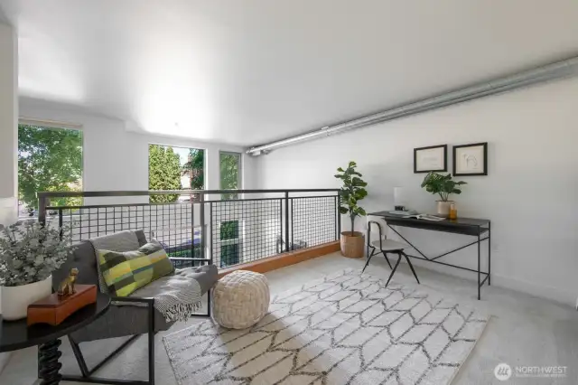 Versatile loft with tree-lined views, ideal for a home office, reading nook, or creative zone.