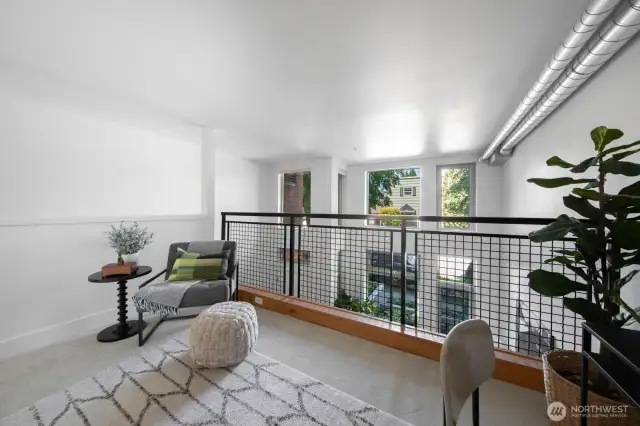 Overhead view of the main space highlights the airy, open-concept layout with industrial touches.