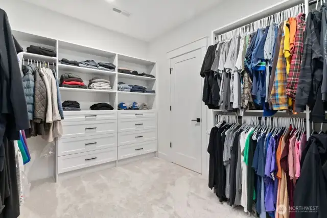 Custom built in primary closet.