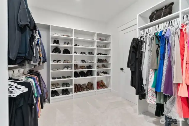 Custom built in primary closet.