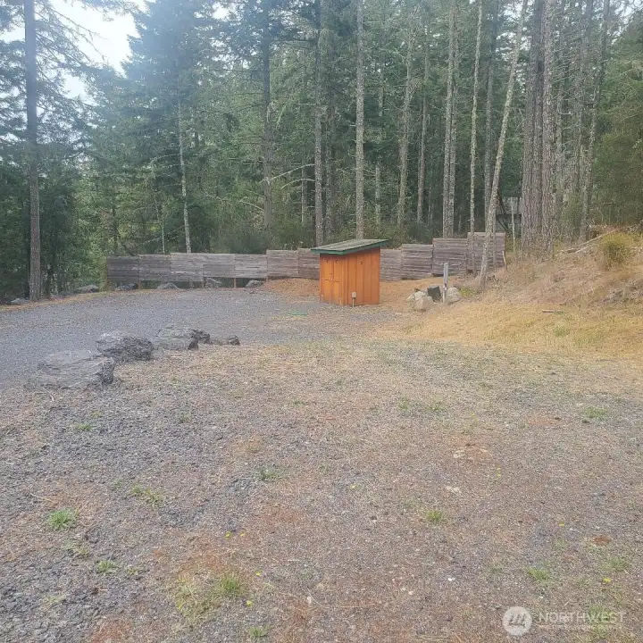 View from upper portion of lot towards pump house for the private Well.