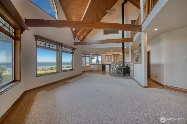 MOVING TOWARD THE KITCHEN THROUGH THE LIVING AREA.  THERE IS A STONE EARTH IN THE CORNER FOR THE WOOD BURNING STOVE!