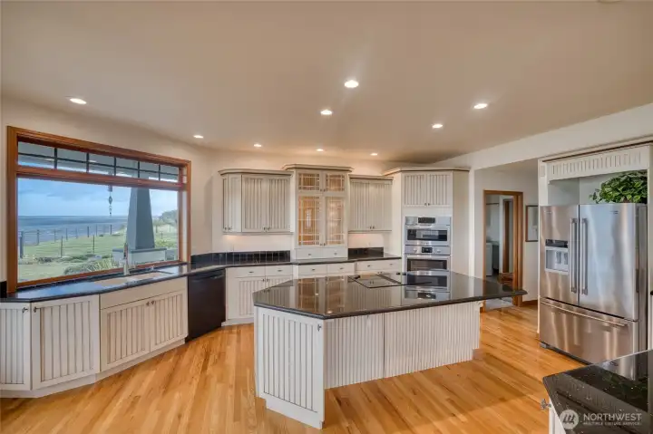 ANY CHEF WOULD ENJOY THE SPACIOUS KITCHEN CUSTOM CABINETRY AND GRANITE COUNTERS! FROM THE KITCHEN WINDOW VIEWS OF THE BAY!