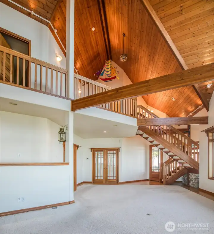 BACK THROUGH THE LIVING AREA TOWARD THE FRENCH DOORS TO THE PRIMARY BEDROOM!
