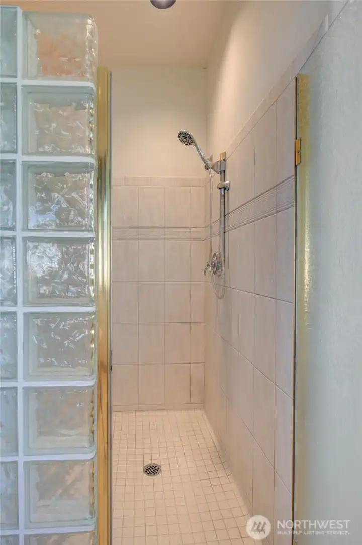 THE GLASSED IN SHOWER IS LARGE ENOUGH FOR TWO!