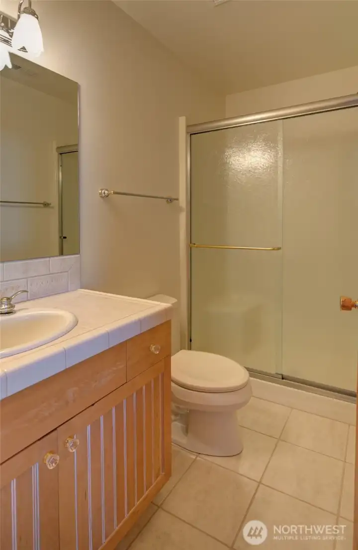 AT THE TOP OF THE STAIRS IS A 3/4 BATH WITH STEP-IN SHOWER FOR GUESTS!