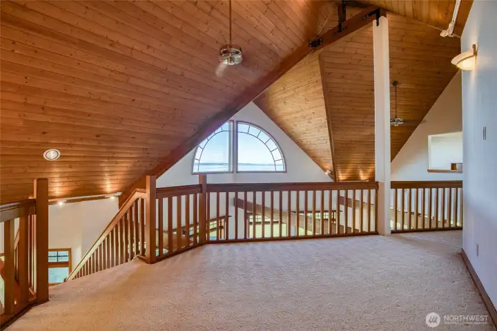THE HALLWAY IS GORGEOUS WITH THE HARDWOOD CATHEDRAL CEILINGS AND THE HALF MOON WINDOW SHOWING OFF THE BAY VIEW!