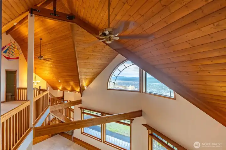 LOOKING OUT THE WINDOW TO ALL THE WOOD TRIM AND VIEW OF THE BAY THROUGH THE HALF-MOON WINDOW!