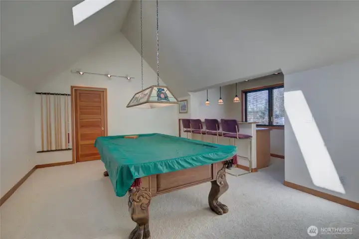 ABOVE ONE OF THE GARAGES IS AN APARTMENT. CURRENTLY THERE IS A POOL TABLE IN THE LIVING ROOM!