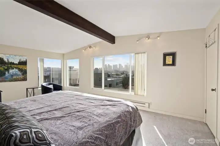 Primary bedroom with wall of windows to enjoy City & Sound views.  Gorgeous!