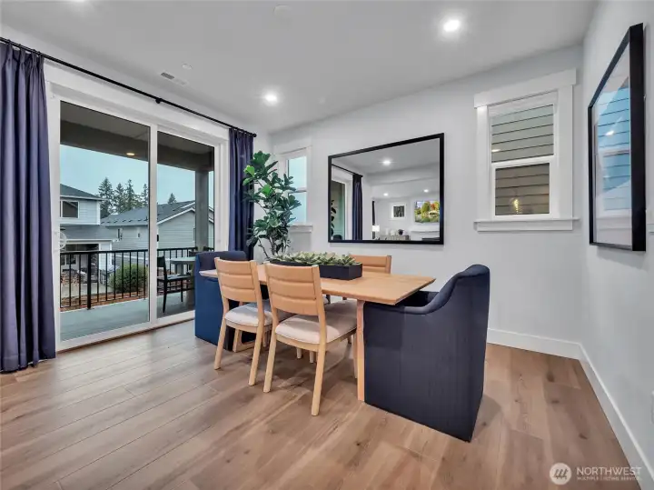 Dining room connects to covered deck providing multi entertaining options- Photo is of model home-Victorian plan-elements of Chateau plan can vary