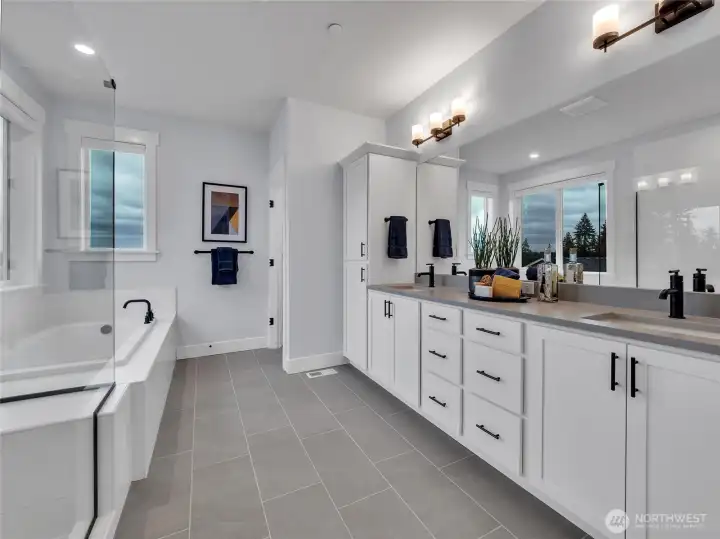 Primary features luxurious soaking tub and private toilet closet.  Photo is of model home-Victorian plan-elements of the Chateau plan can vary