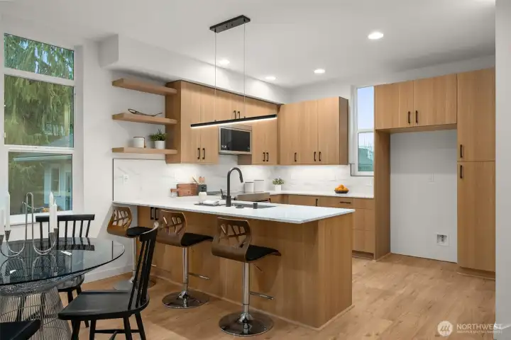 Kitchen offers oodles of countertop and cabinet storage space.  Peninsula offers seating and storage!  Photos are staged model of similar floorplan. Color scheme and layout will differ.