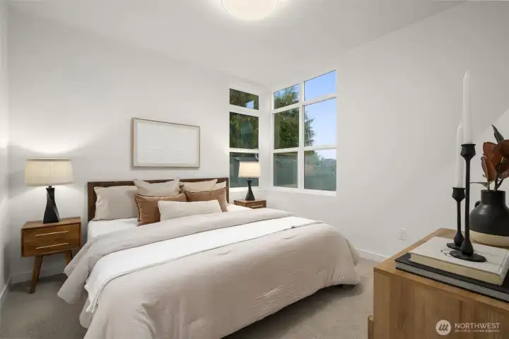 Primary Suite offers plenty of space for King Size bed.  Photos are staged model of similar floorplan. Color scheme and layout will differ.