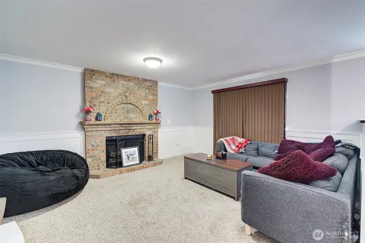 Cozy wood fireplace graces the family room with access to rear deck