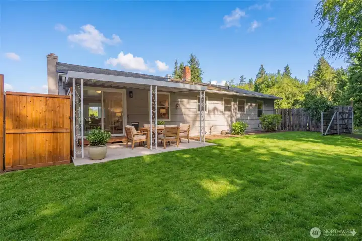 Fenced back yard. The patio furnishings are virtually staged.