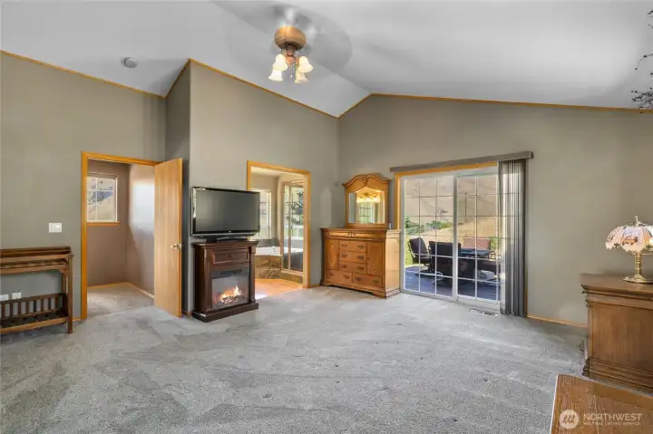 Main level primary suite is tucked away at the end of the house for privacy.