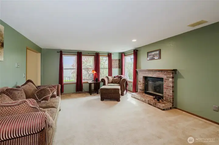 Formal living room with masonry fireplace and wood mantle.