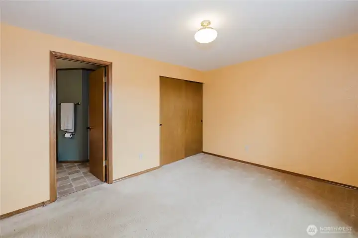 Main floor bedroom with adjoining full bathroom.