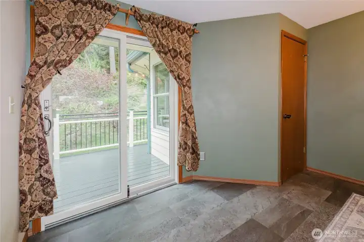 Primary bedroom has two separate sliding glass doors to the outside deck.  Flooring replaced about a year ago.