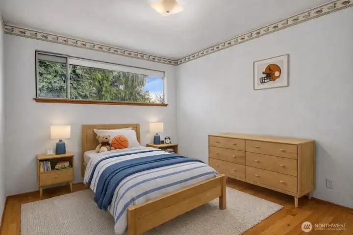 One of 3 bedrooms on the main floor with nice hardwood floors. Virtually staged.