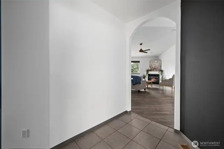 Tiled in entry way with view into living room.
