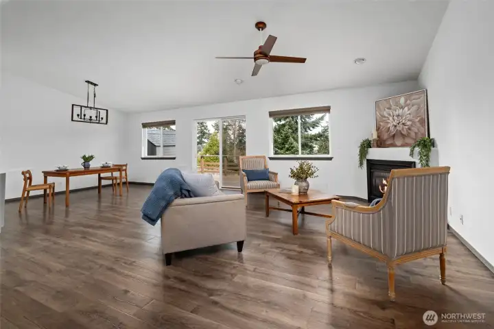 Vaulted ceilings, ceiling fan, and beautiful new light fixtures make this a very inviting living space.