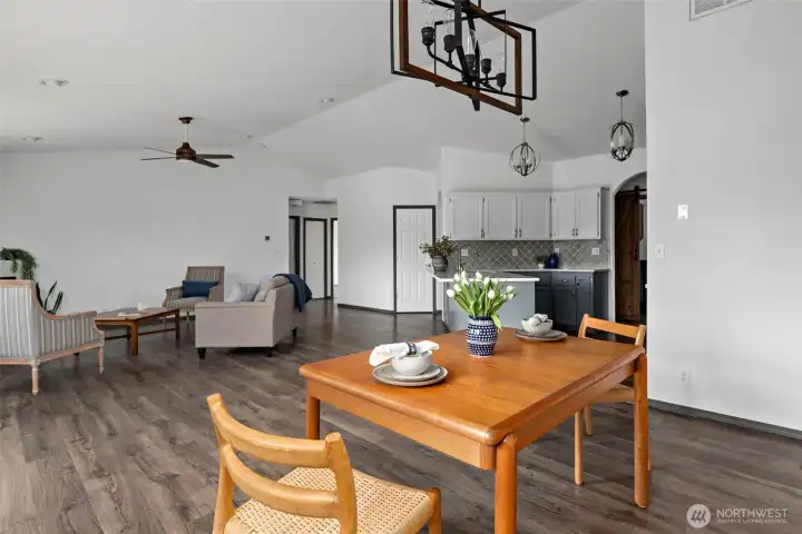 Dining area with beautiful updated light fixture.