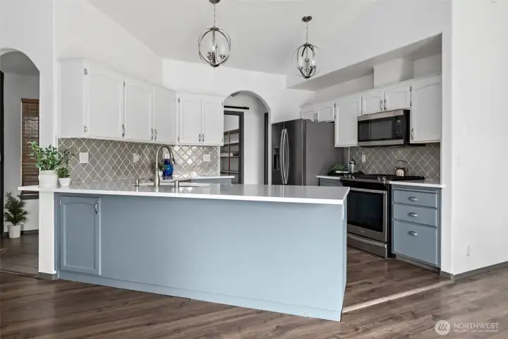 Beautiful light fixtures add a luxury feel to the updated kitchen.