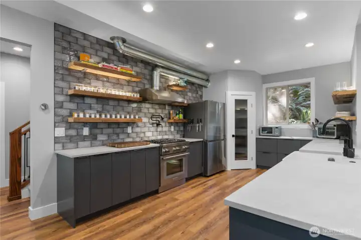 The kitchen has a walk in pantry and Dacor fridge.