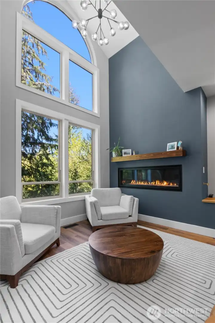 Soaring ceilings and large windows make this space feel bright and inviting while the large 6' gas fireplace offers warmth and comfort.