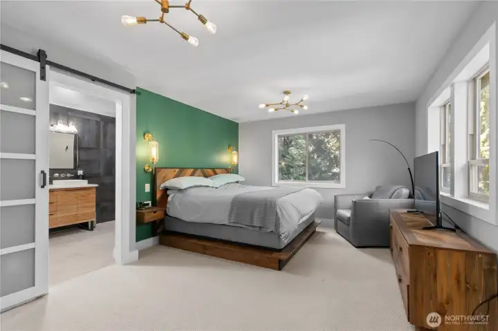 The second primary bedroom features an en suite bathroom and custom all wood walk-in closet.