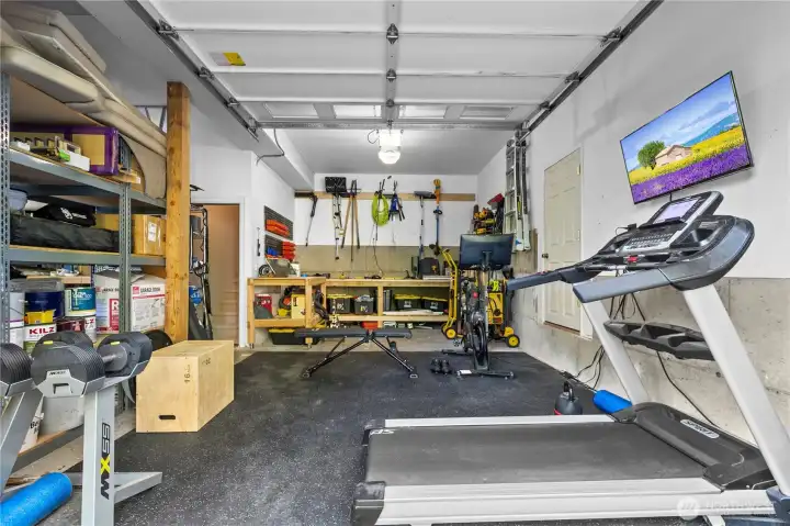 Pictured is only half of the large garage offering plenty of space for storage and even a gym!