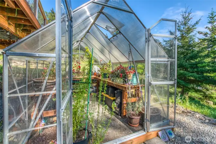 A sunny greenhouse space for year-round growing and gardening.