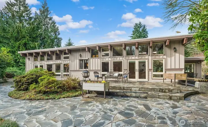 Embodying the classic tenants of Mid-Century Modern design, this home seamlessly blends into its natural surroundings creating a serene backyard oasis.