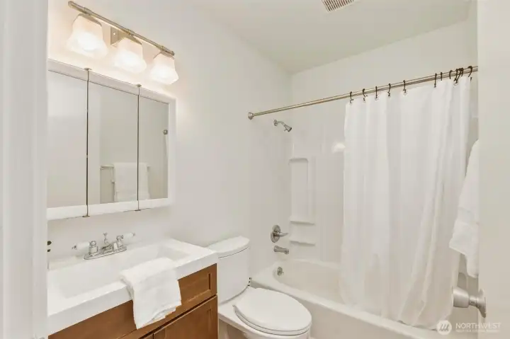 Updated bathroom with newer tub/shower surround Updated bathroom with newer tub/shower surround