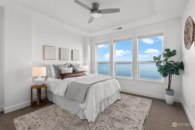 The primary bedroom is a true oasis and retreat, offering a breath of fresh air and expansive water views that make everyday living feel like a tranquil vacation