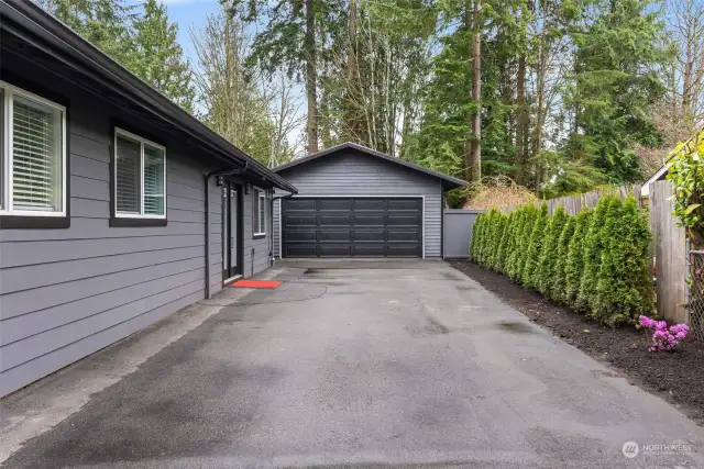 On your way to the entrance, facing the spacious garage.