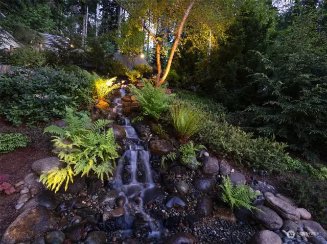 Stunning waterfall greets you as you walk to the front door.