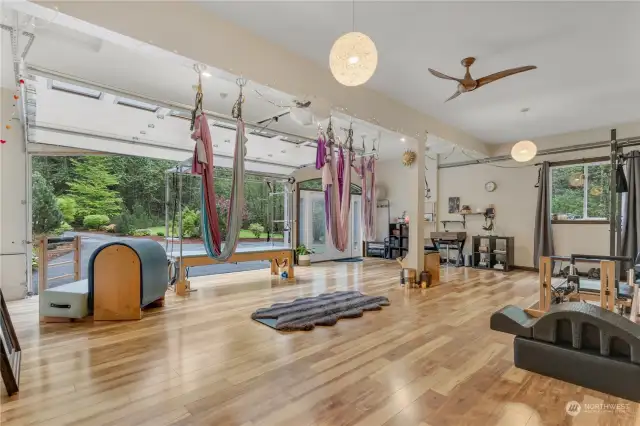 3 car garage converted into a yoga/pilates studio with garage doors open.  Has a private entrance door to studio.