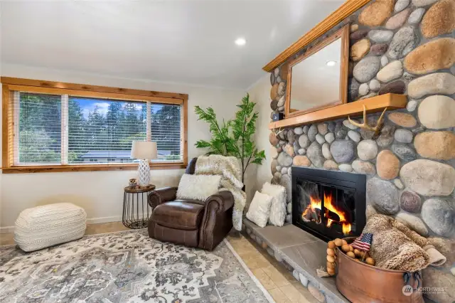 Beautiful River Rock surrounds the wood burning fireplace. Lovely mantle