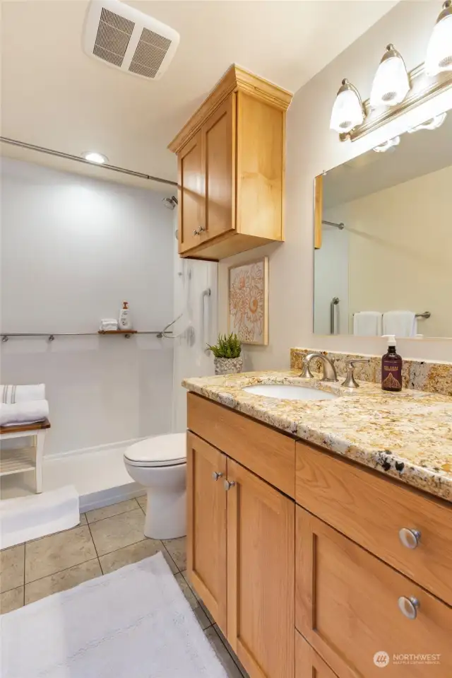 Newly renovated bathroom on upper level has walk-in shower, granite countertops, lovely shower surround and more!