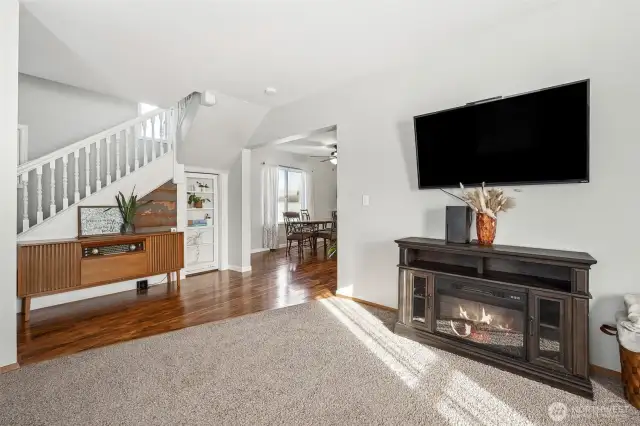Heart of the Home – Living Room Anchored by Open Stairway
