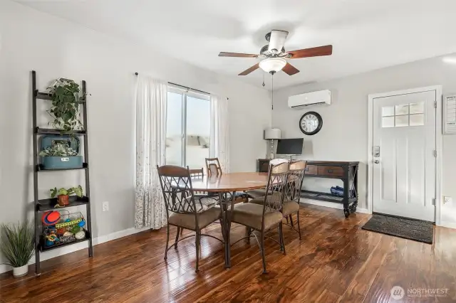 Sunlit Dining Room Featuring Big Window and Convenient Rear Entry