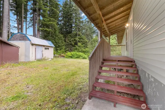 Covered deck and stairs welcome you to your front entry
