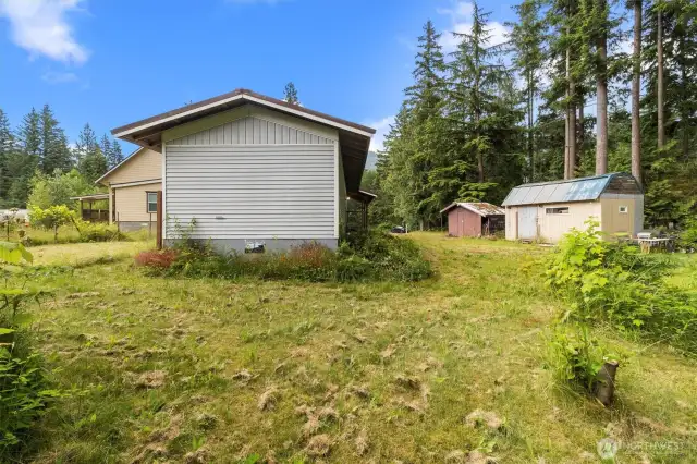 View from the back with the two sheds to the side of the property