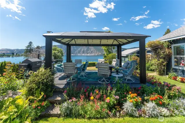 Covered patio offers year-round enjoyment with breathtaking lake and mountain views — a front-row seat to sunrise serenity and sunset skies.