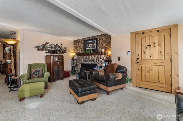 Cozy up by the stunning wood-burning fireplace, beautifully accented with natural rock — the centerpiece of the main living room and perfect for year-round ambiance.